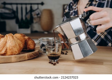 Breakfast at home fresh espresso coffee from the classic Italian geyser coffee maker moka and croissants on the table