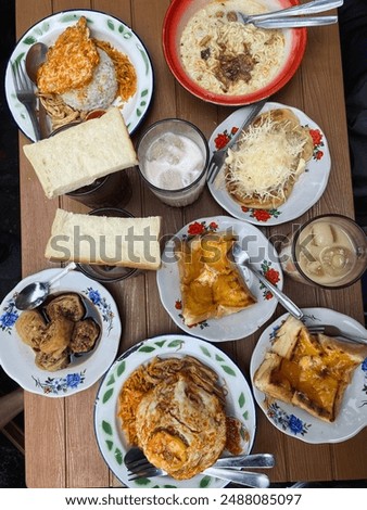 Breakfast at Kopitiam. The menu typically includes a range of dishes such as toast with kaya (coconut and egg jam), soft-boiled eggs, noodles, various types of rice, traditional coffee, and tea.
