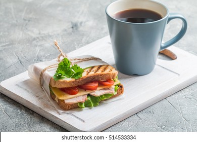 Breakfast And Lunch - Sandwich And Coffee On Cutting Board