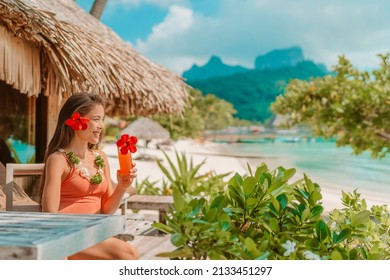 Breakfast at luxury hotel room on beach. Asian woman drinking fruit juice morning on summer vacation travel in Bora Bora island, Tahiti French Polynesia landscape. Happy tourist relaxing on holiday. - Shutterstock ID 2133451297
