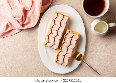 Breakfast with the mille-feuille, or millefeuille, is a piece of French pastry made from three layers of puff pastry and two layers of pastry cream. Dessert is iced with icing sugar. Directly above. - Powered by Shutterstock