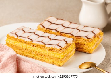 Breakfast with the mille-feuille, or millefeuille, is a piece of French pastry made from three layers of puff pastry and two layers of pastry cream. The top of dessert is iced with icing sugar.