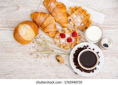 Breakfast in the morning, black coffee cup with bread, Croissant and fruit on the wooden table. - Shutterstock ID 1765940735