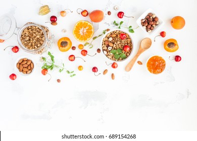 Breakfast With Muesli, Fruits, Berries, Nuts On White Background. Healthy Food Concept. Flat Lay, Top View, Copy Space