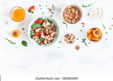 Breakfast With Muesli, Strawberry Salad, Fresh Fruit, Nuts On White Background. Healthy Food Concept. Flat Lay, Top View