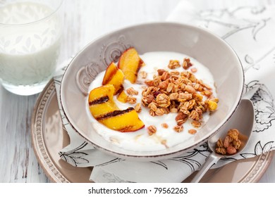 Breakfast with muesli,yogurt and grilled peaches