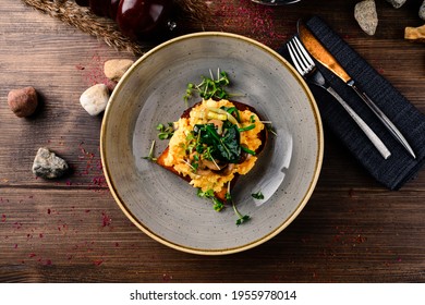 Breakfast Omelette With Champignon On Wooden Background, Toast With Omelet And Mushrooms. Scrambled Egg With Mushrooms On Toast. Food Recipe Background