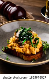 Breakfast Omelette With Champignon On Wooden Background, Toast With Omelet And Mushrooms. Scrambled Egg With Mushrooms On Toast. Food Recipe Background