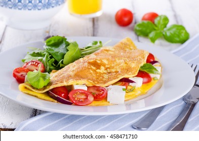 Breakfast Of Omelette With Cherry Tomatoes And Feta Cheese On White