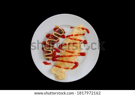 breakfast omelette and sausage with mustard and ketchup. what better way to start your day
