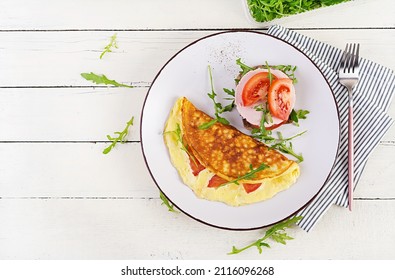 Breakfast. Omelette With Tomatoes, Cheese And Sandwich With Boiled Sausage.  Frittata - Italian Omelet. Top View, Overhead