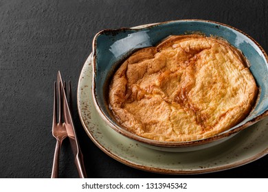 Breakfast, Omelette with vegetables and herbs on plate over black table surface. Healthy food - Shutterstock ID 1313945342