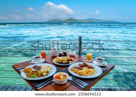 Breakfast on the beach by the pool with a look over the ocean of La Digue Seychelles,tropical Island