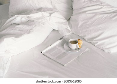 Breakfast on the bed in the hotel room. Breakfast in a snow-white bed, coffee with a croissant. Cozy morning. Breakfast in bed. - Shutterstock ID 2083662085