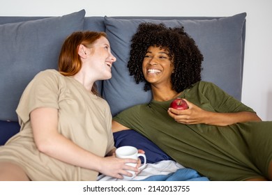 Breakfast on bed for a young lesbian couple of women, diversity and lgbt people concept - Powered by Shutterstock