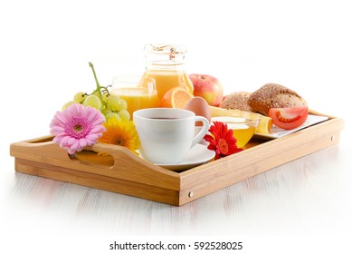 Breakfast on tray served with coffee, orange juice, egg, rolls and honey. Balanced diet.