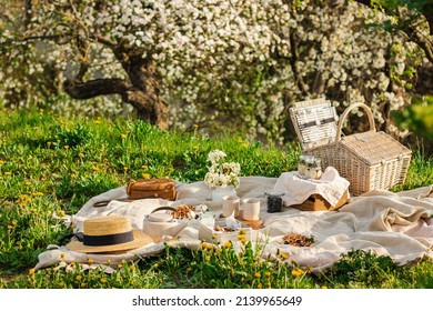 Breakfast picnic with waffles and tea in spring blossom garden on a white tablecloth on a sunny day, cherry blossoms. Outdoor, picnic, brunch, spring mood - Shutterstock ID 2139965649