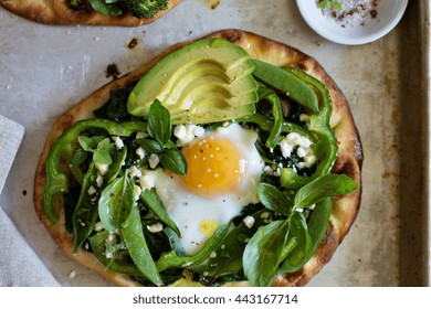 Breakfast Pizza On Pita With Baked Egg, Spinach And Green Vegetables