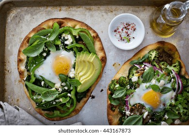 Breakfast Pizza On Pita With Baked Egg, Spinach And Green Vegetables