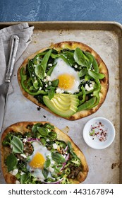 Breakfast Pizza On Pita With Baked Egg, Spinach And Green Vegetables