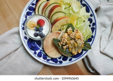 Breakfast Plate On  Wooden Table: Canned Tuna And Corn Scrambled Egg On English Muffin With Fruit Yogurt Salad