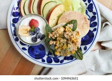 Breakfast Plate On  Wooden Table: Canned Tuna And Corn Scrambled Egg On English Muffin With Fruit Yogurt Salad