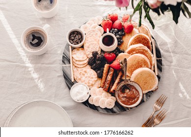 Breakfast Platter. Table Setting. Pancakes, Breakfast Sausages, Berries, Fruits, Chocolate Spread And Coffee. Morning Light. White And Grey Colors. Peonies. Summer Time. Sunday Brunch Party. Weekend