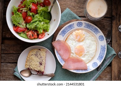 Breakfast. Salad With Tomatoes And Lettuce, Scrambled Eggs With Bacon And A Piece Of Crumble