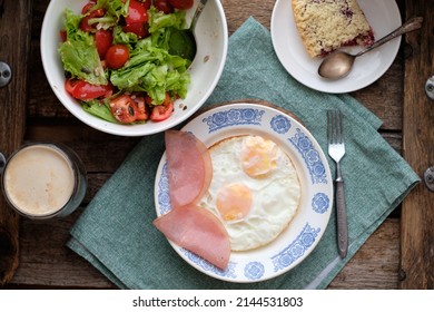 Breakfast. Salad With Tomatoes And Lettuce, Scrambled Eggs With Bacon And A Piece Of Crumble