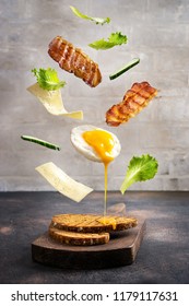 Breakfast sandwich in levitation above cutting board