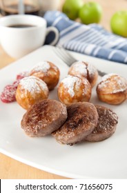 Breakfast Sausage Patties Served With Danish Pancakes And Raspberries