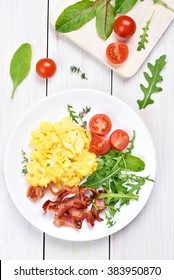 Breakfast With Scrambled Eggs, Bacon And Vegetable Salad, Top View.