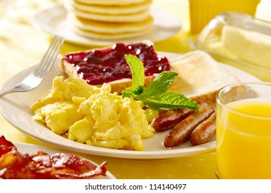 Breakfast With Scrambled Eggs, Sausage Links And Toast.