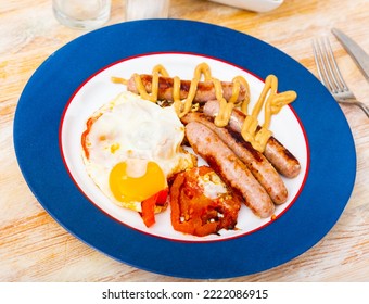 Breakfast With Scrambled Eggs, Sausage And Tomatoes Closeup