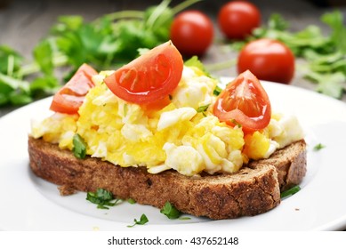 Breakfast Scrambled Eggs And Tomato Slices On Bread