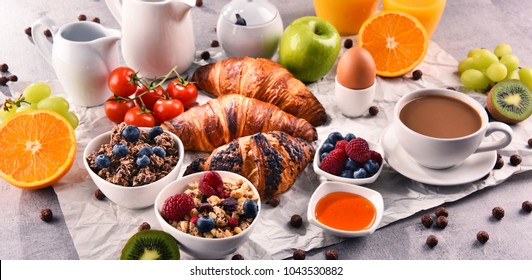 Breakfast served with coffee, orange juice, croissants, egg, cereals and fruits. Balanced diet.