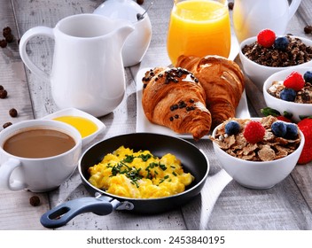 Breakfast served with coffee, orange juice, croissants, egg, cereals and fruits. Balanced diet.