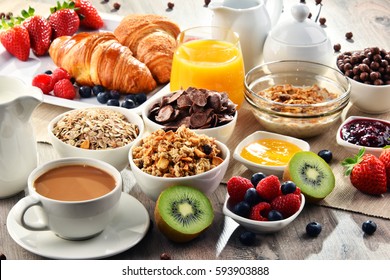 Breakfast served with coffee, orange juice, croissants, cereals and fruits. Balanced diet. - Shutterstock ID 593903888