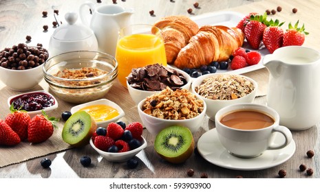 Breakfast served with coffee, orange juice, croissants, cereals and fruits. Balanced diet. - Shutterstock ID 593903900