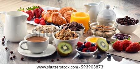 Breakfast served with coffee, orange juice, croissants, cereals and fruits. Balanced diet.