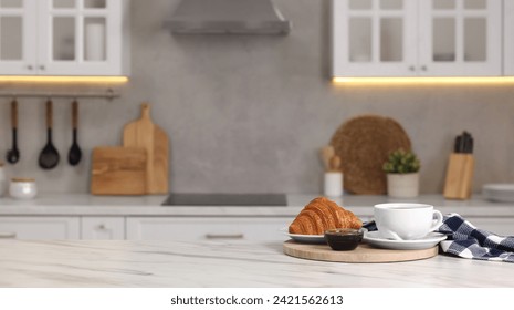 Breakfast served in kitchen. Fresh croissant, coffee, and jam on white table. Space for text - Powered by Shutterstock