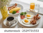 Breakfast set at hotels in Thailand, including hot coffee, eggs, ham and sausage.