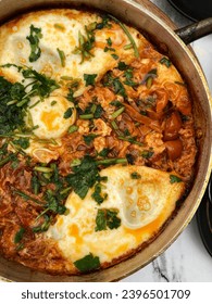 Breakfast Shakshuka. Shakshouka Made of Poached Eggs in Tomato and Pepper Sauce, Served in Cast Iron Pan on Cafe Table, Top View. - Shutterstock ID 2396501709