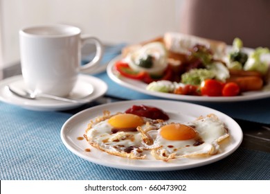Breakfast , sunny side up fried eggs with salad and coffee cup