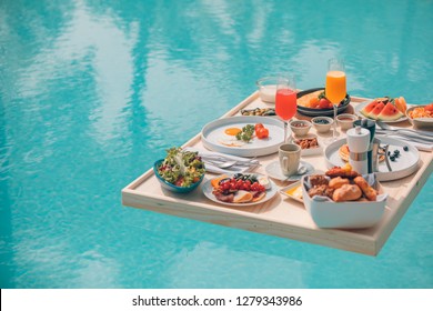 Breakfast In Swimming Pool, Floating Breakfast In Tropical Resort. Table Relaxing In Calm Pool Water, Healthy Breakfast And Fruit Plate By Resort Pool. Exotic Summer Diet. Tropical Beach Lifestyle