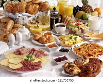 BREAKFAST TABLE FILLED WITH ASSORTED FOODS,SAVOURY,SWEET,PASTRIES,HOT AND COLD DRINKS