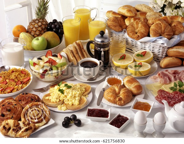 breakfast-table-filled-assorted-foodssavourysweetpastrieshot-600w-621756830.jpg