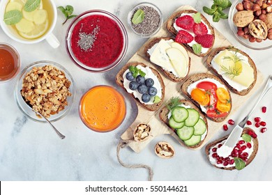 Breakfast table with granola, fresh smoothie, juice and various of sandwiches. Healthy eating concept - Powered by Shutterstock