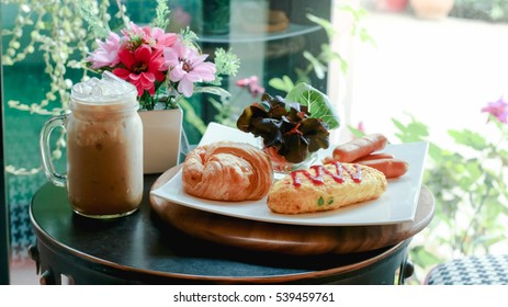 Breakfast Table Set, Croissant Bread , Omelet , Sausage And Ice Coffee Ready To Serve.