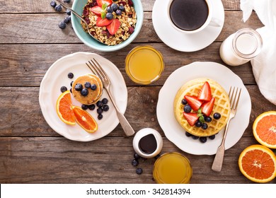 Breakfast table with waffles, granola and fresh berries - Powered by Shutterstock